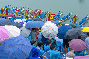 龙舟赛当天，尽管细雨绵绵，却未能阻挡来自全国各地乃至世界各地的龙舟赛爱好者们热情洋溢的步伐。他们齐聚在屈原的故里——秭归的江边，期待着赛事的举行。.jpg